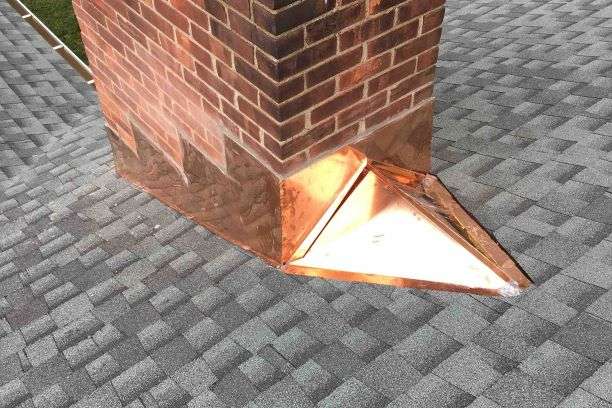 A photo of a copper chimney being repaired by a Storm Proof Roofing Systems technician, showcasing their expertise in chimney repair services.