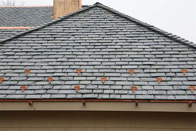 Tiles being installed on a roof, showcasing the quality workmanship of Storm Proof Roofing Systems.