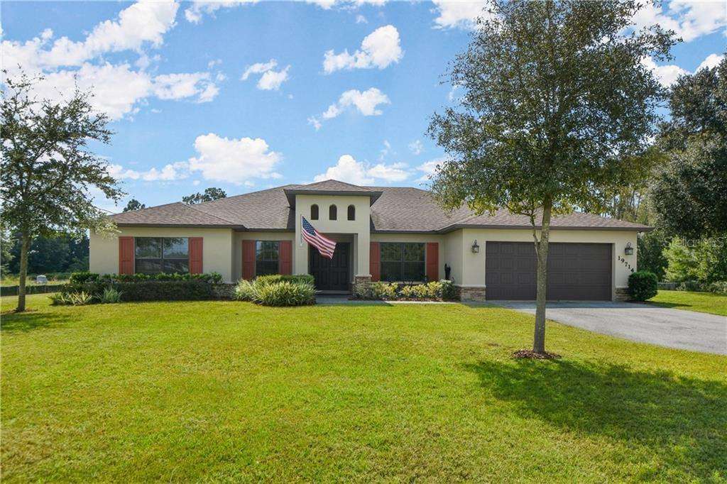 A photo of a beautiful residential home with a well-maintained and sturdy roof installed by Storm-Proof Your Roof, showcasing the company's expertise in delivering top-quality residential roofing services using high-quality materials and techniques.