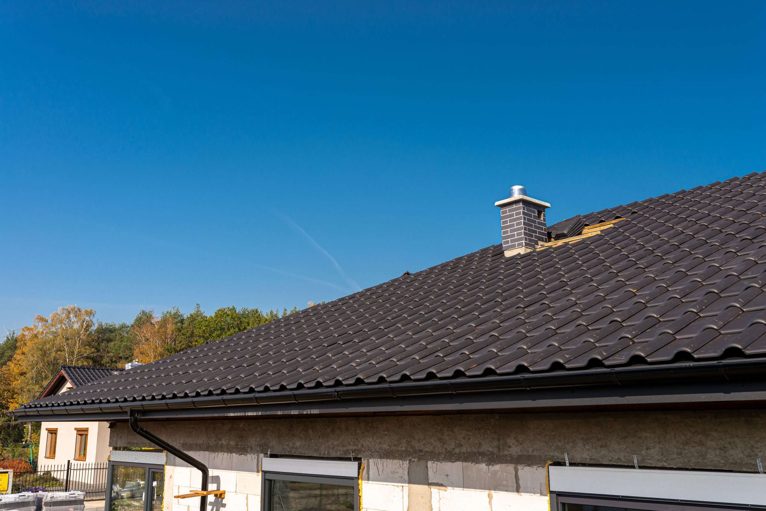 A residential roof with brand new tiles installed, providing a fresh and updated look.