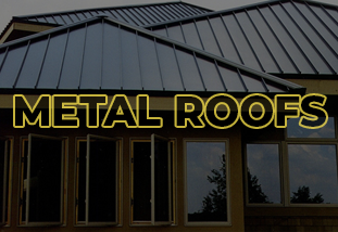 A close-up photo of a metal roof with overlapping panels and visible screws, installed on a house.