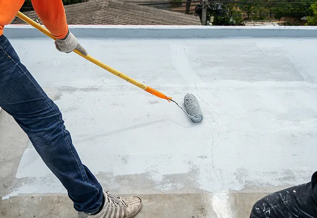 Application of waterproof roof coating on a roof surface