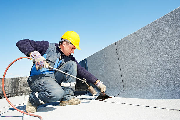 Roof waterproofing contractors working on a roof.