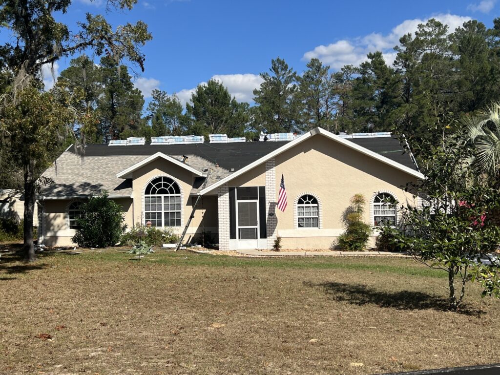 A team of roofers installing a new roof on a house in Citrus County.