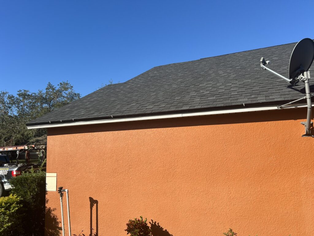 Close-up of energy-efficient asphalt shingles reflecting sunlight on a home in Inverness, FL.