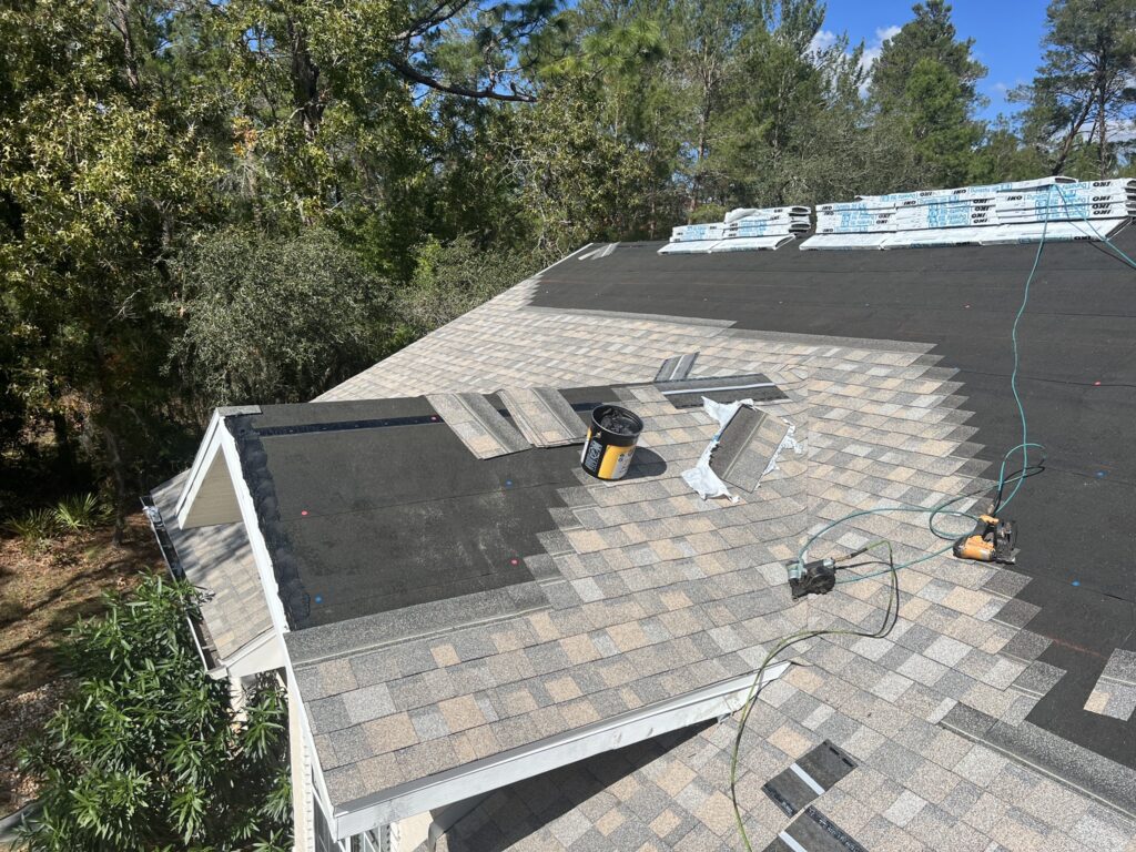 A roofer examining shingles during a roof inspection in Citrus County.