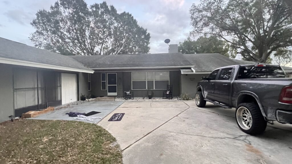  A skilled roofing contractor working on a residential roof in Inverness, FL, ensuring high-quality installation.