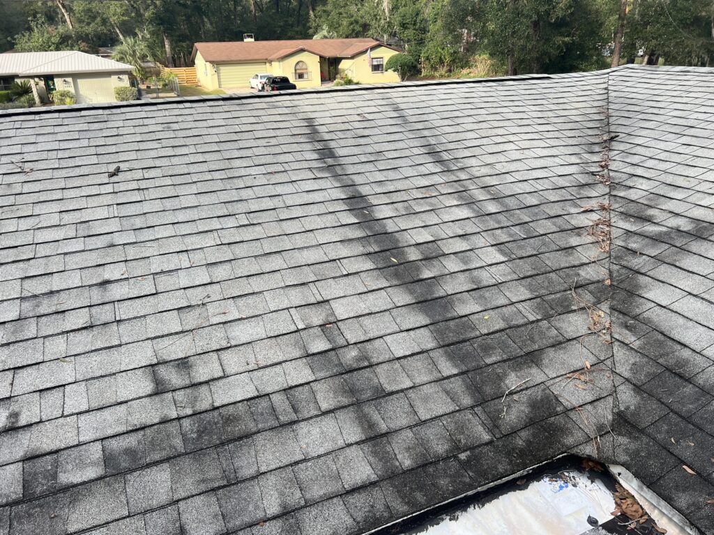 Roofing contractor inspecting a roof for damage in Inverness, FL.