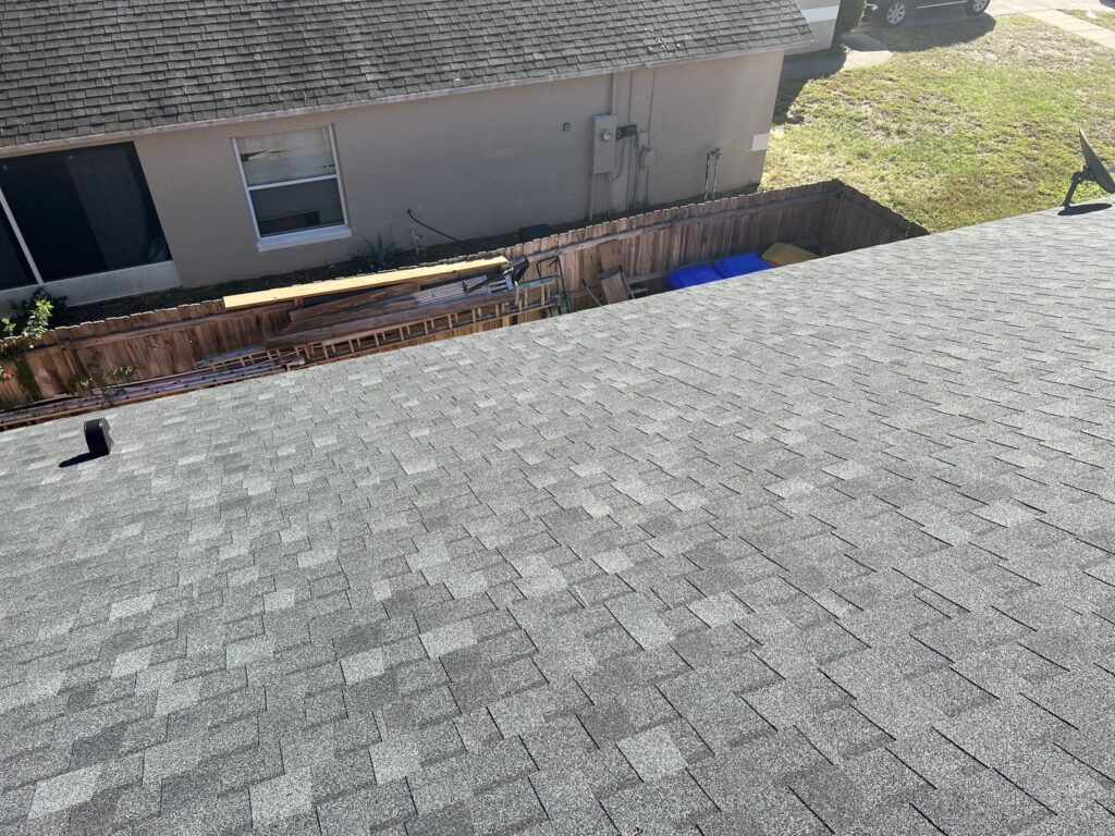 A newly installed asphalt shingle roof on a modern home in Citrus County, FL.