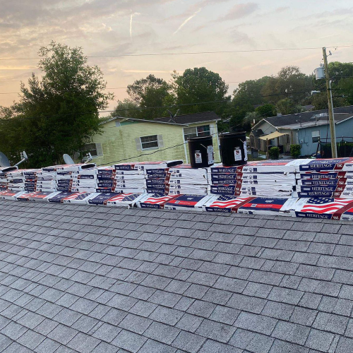 Worker preparing the roof decking for shingle installation